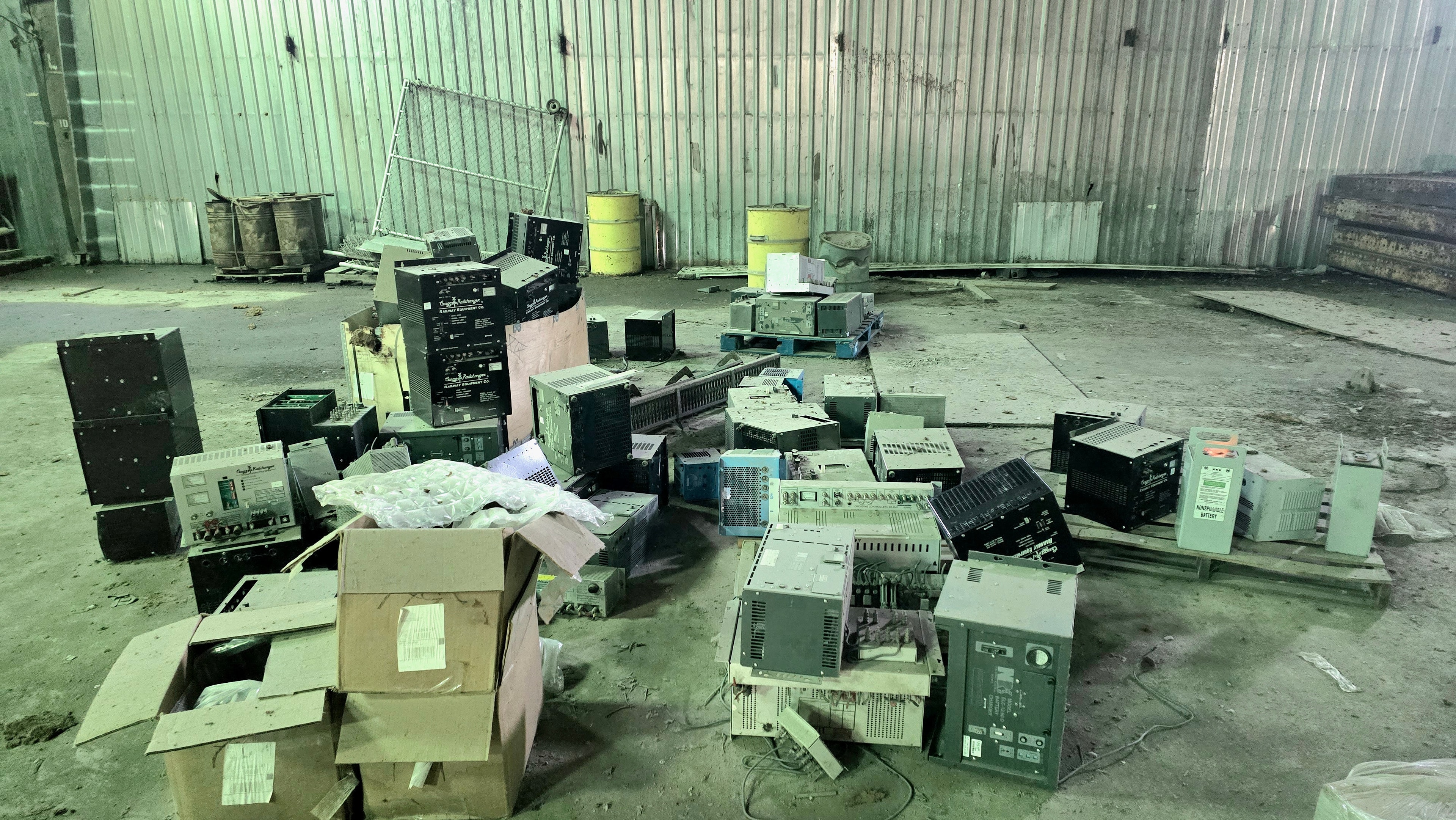 Mixed electronics and e-waste on warehouse floor before sorting
